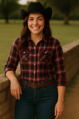 Lauren wearing a flannel shirt, cowgirl hat and blue jeans.